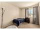 Bright bedroom featuring a single bed, dark dresser, and natural light from large windows at 1676 W Sequoia Dr, Phoenix, AZ 85027