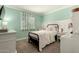 Stylish bedroom with unique decor, a black iron bed, and a bright window with hanging vines at 1676 W Sequoia Dr, Phoenix, AZ 85027
