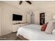 Comfortable bedroom with TV, ceiling fan, and closet for clothing storage at 1676 W Sequoia Dr, Phoenix, AZ 85027