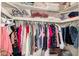 Open closet full of neatly hung clothes and folded linens on the overhead shelving at 1676 W Sequoia Dr, Phoenix, AZ 85027
