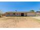 Single-story home with solar panels, light-colored siding and desert landscaping at 1676 W Sequoia Dr, Phoenix, AZ 85027