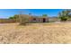 Single-story home with solar panels, light-colored siding and desert landscaping at 1676 W Sequoia Dr, Phoenix, AZ 85027