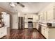 Charming kitchen with stainless steel appliances, dark wood-style floors, ample counter space and storage at 1676 W Sequoia Dr, Phoenix, AZ 85027