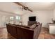 Bright living room with a vaulted ceiling, tile flooring, a ceiling fan and a sliding door leading to the backyard at 1676 W Sequoia Dr, Phoenix, AZ 85027