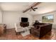 Comfortable living room featuring exposed beam, tile flooring, a ceiling fan and lots of natural light at 1676 W Sequoia Dr, Phoenix, AZ 85027