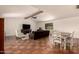 Open living room with tile flooring, dining table and large sectional sofa at 1676 W Sequoia Dr, Phoenix, AZ 85027