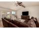 Inviting living room featuring exposed beam, tile flooring, neutral decor, a ceiling fan and lots of natural light at 1676 W Sequoia Dr, Phoenix, AZ 85027