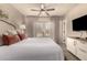 Bright bedroom featuring a king bed, soft lighting, and patio access for a relaxing retreat at 1676 W Sequoia Dr, Phoenix, AZ 85027