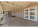 Spacious covered patio with dual French doors creates a seamless indoor-outdoor living experience at 1676 W Sequoia Dr, Phoenix, AZ 85027