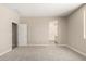 Bright bedroom featuring neutral carpeting, access to ensuite bathroom, and ample natural light at 17032 W Cavedale Dr, Surprise, AZ 85387