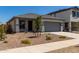 Charming single-story home with gray trim, a gray garage door, and desert landscaping at 17032 W Cavedale Dr, Surprise, AZ 85387