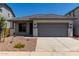 Charming single-story home with gray trim, a gray garage door, and desert landscaping at 17032 W Cavedale Dr, Surprise, AZ 85387