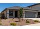 Charming single-story home with gray trim, a gray garage door, and desert landscaping at 17032 W Cavedale Dr, Surprise, AZ 85387