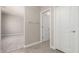 Hallway featuring tile flooring, neutral walls, with access to a bedroom and bathroom at 17032 W Cavedale Dr, Surprise, AZ 85387