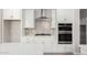 Bright white kitchen with stainless steel appliances, and modern finishes at 17032 W Cavedale Dr, Surprise, AZ 85387