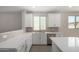 Bright white kitchen with stainless steel appliances, modern finishes, and an island at 17032 W Cavedale Dr, Surprise, AZ 85387