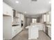 Bright white kitchen with stainless steel appliances, modern finishes, and an island at 17032 W Cavedale Dr, Surprise, AZ 85387
