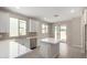 Bright white kitchen with stainless steel appliances, modern finishes, and an island at 17032 W Cavedale Dr, Surprise, AZ 85387