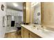 Well-lit bathroom with a white countertop, vanity, and a shower with glass doors at 17200 W Bell Rd # 1602, Surprise, AZ 85374