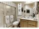 Bright bathroom featuring a shower, toilet, vanity with a white sink, and matching cabinet at 17200 W Bell Rd # 1602, Surprise, AZ 85374