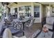 Relaxing covered patio with an outdoor dining table and view of palm trees and the golf course at 17200 W Bell Rd # 1602, Surprise, AZ 85374