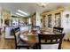 Charming dining area with wooden table and hutch, adjacent to a functional kitchen with stainless steel appliances at 17200 W Bell Rd # 1602, Surprise, AZ 85374