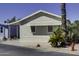 Well-maintained home with trimmed shrubbery and carport on a quiet street, with views of nearby homes at 17200 W Bell Rd # 1602, Surprise, AZ 85374