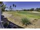 Scenic view of a golf course lined with palm trees under a clear blue sky at 17200 W Bell Rd # 1602, Surprise, AZ 85374