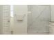 Elegant bathroom featuring a glass-enclosed shower with a marble-look surround at 17473 W Victory St, Goodyear, AZ 85338
