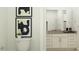 Clean bathroom with white cabinets, neutral countertops, and framed abstract art at 17473 W Victory St, Goodyear, AZ 85338