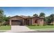 Charming single-story home with a tile roof, desert landscaping, and an attached two-car garage at 17473 W Victory St, Goodyear, AZ 85338