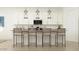 Modern kitchen with stainless steel appliances, overhead lighting, and barstool seating at the counter at 17473 W Victory St, Goodyear, AZ 85338
