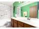 Well-lit bathroom featuring a spacious vanity and a shower-tub combo at 1807 E Jamaica Ave, Mesa, AZ 85204