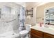 Bathroom featuring a walk-in shower with accessible grab bar, a toilet, and a vanity sink with wood cabinets at 1807 E Jamaica Ave, Mesa, AZ 85204