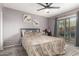 Cozy bedroom with plush carpeting, large window, and sliding glass door leading to the outside at 1807 E Jamaica Ave, Mesa, AZ 85204