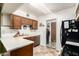 Efficient kitchen with laminate countertops and wooden cabinets, complete with appliances and adjacent laundry area at 1807 E Jamaica Ave, Mesa, AZ 85204