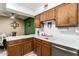 Functional kitchen with wooden cabinetry, white countertops and stainless steel dishwasher at 1807 E Jamaica Ave, Mesa, AZ 85204