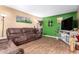 Inviting living room featuring a comfortable brown sofa and neutral walls, perfect for relaxation at 1807 E Jamaica Ave, Mesa, AZ 85204