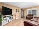 Inviting living room with wood-look flooring, comfortable seating, and large windows for natural light and entertainment at 1807 E Jamaica Ave, Mesa, AZ 85204
