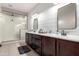 Bright bathroom features double vanity with modern fixtures and spacious glass shower at 18334 W Marshall Ln, Surprise, AZ 85388