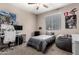 Teen bedroom with modern furniture and decor, featuring a desk with computer and a large beanbag chair at 18334 W Marshall Ln, Surprise, AZ 85388