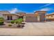 Charming single-Gathering home featuring a three-car garage, desert landscaping, and a neutral color palette at 18334 W Marshall Ln, Surprise, AZ 85388