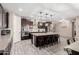 Stylish eat-in kitchen with an island, barstool seating, modern lighting, and plenty of counter space at 18334 W Marshall Ln, Surprise, AZ 85388