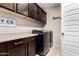 Well-organized laundry room with cabinets and counter space, features modern appliances at 18334 W Marshall Ln, Surprise, AZ 85388