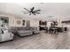 Spacious living area with a large sectional couch, seamlessly connecting to the kitchen and dining spaces at 18334 W Marshall Ln, Surprise, AZ 85388