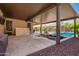 Spacious covered patio with an outdoor bar and a built in fire pit overlooking the pool at 18334 W Marshall Ln, Surprise, AZ 85388