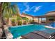 Backyard pool, featuring luxurious lounge chairs, a patio, and beautiful desert landscaping at 18334 W Marshall Ln, Surprise, AZ 85388