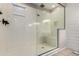 Bright shower features a glass enclosure and built in bench at 18334 W Marshall Ln, Surprise, AZ 85388