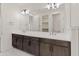 Bright bathroom featuring a double vanity with dark wood cabinets, a large mirror, and tile flooring at 2121 W Sonoran Desert Dr # 14, Phoenix, AZ 85085
