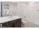 Bathroom with vanity, dark wood cabinets, and shower over bath at 2121 W Sonoran Desert Dr # 14, Phoenix, AZ 85085
